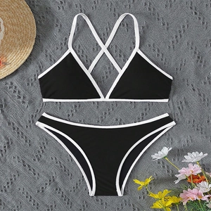 Flat lay of a black and white color-block bikini set with halter top and low-waist bottom