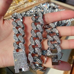 Close-up of 20mm iced out silver Cuban link chains with shimmering crystal pavé rhinestones