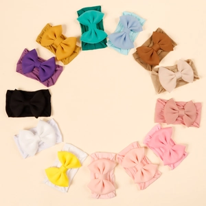 Set of 12 colorful nylon baby headbands with large soft bows in various colors
