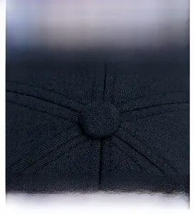 Detailed macro shot of dark blue baseball cap crown featuring button and stitching