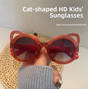 Detailed close-up of red glitter cat-ear sunglasses with UV protection for kids