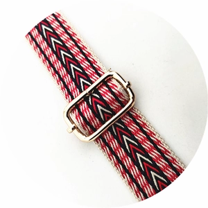 Macro view of ethnic jacquard woven strap with a gold metal adjustable buckle