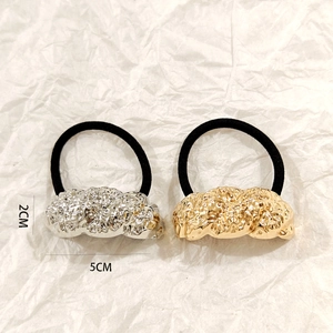 Detail of silver and gold hollow metal hair rings with dimensions 2CM by 5CM