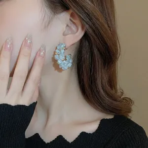 French style C-shaped earrings with light blue aquamarine stones and gold beaded accents