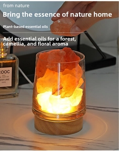 Detailed view of Himalayan salt lamp with crystal rocks on a wooden base for aromatherapy