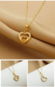 Macro shot of gold-plated double heart pendant with cubic zirconia on a luxury silk backdrop
