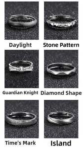 Close-up of six textured silver rings featuring geometric and organic patterns