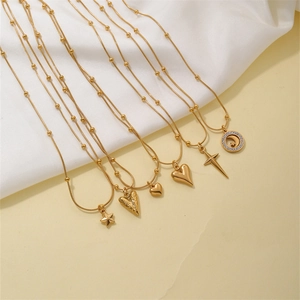Gold titanium necklaces featuring star, heart, cross and moon pendants on bead chains