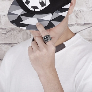 Close-up of vintage punk cross ring in antique silver on model finger with street style