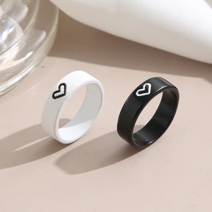 Minimalist black and white heart enamel rings for couples with a sleek lacquered finish