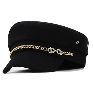 Black cotton military cap with a chunky gold chain and rhinestone equestrian buckle detail