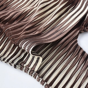 Close-up of the pleated wave pattern knit fabric on a brown halter neck maxi dress