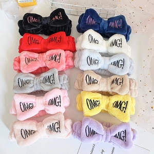 Set of colorful plush OMG bow headbands for washing face, arranged in multiple vibrant colors