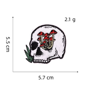 Detail showing dimensions of skull and mushroom embroidered patch, 5.5cm by 5.7cm