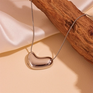 Silver stainless steel snake chain necklace with an irregular heart-shaped pendant on silk