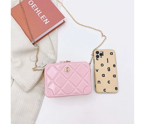 Detail of pink PVC quilted mini bag with gold chain strap and floral decorative buckle