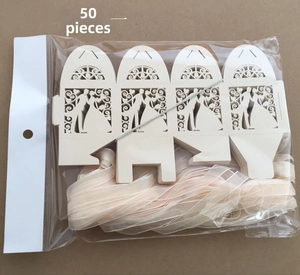 Detailed view of 50-piece set laser cut ivory wedding favor boxes with champagne ribbons