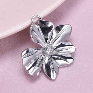 Detailed macro view of a silver flower pendant made of polished 304 stainless steel