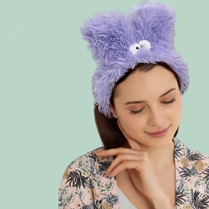 Cute purple plush rabbit ear headband for face washing and yoga on mint background