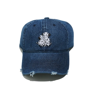 Detail of distressed denim baseball cap featuring two dalmatian embroidery patterns