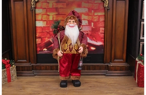 Close-up of standing Santa Claus figure with golden lantern and festive red pine accessories