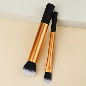 Detail of premium dual-tone bristles and metallic orange makeup brush set