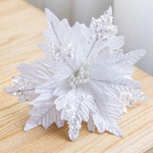 25cm white Christmas velvet poinsettia with silver sequins on a wooden background