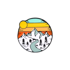 Outdoor nature enamel pin featuring a colorful sunset mountain and river landscape