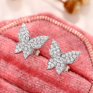 Macro shot of silver butterfly earrings with sparkling cubic zirconia in a pink velvet box
