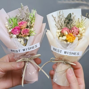 Detailed view of handmade mini dried flower bouquets with roses and gypsophila wrap