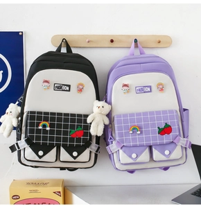 Detail view of large capacity school backpack with plaid pattern and cute plush charms