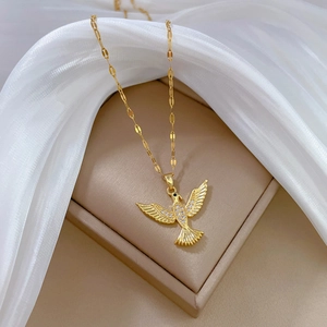 Luxurious gold titanium steel necklace featuring a sparkling crystal bird pendant on soft silk