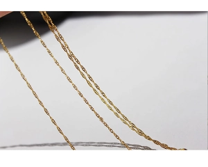 Detailed close-up of the delicate 18k gold-plated twisted rope chain with metallic texture