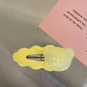 Close-up of a cute yellow bear hair clip with a sturdy metal BB snap fastener