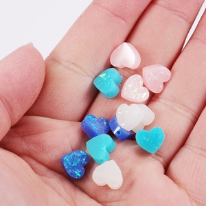 8mm heart-shaped synthetic opal resin beads with 1.5mm holes shown in hand