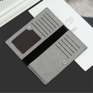 Detail of grey canvas men's long wallet with multi-card slots and snap closure