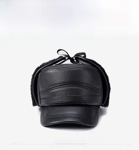 Detail of winter men's black leather hat with warm faux fur lining and plush ear flaps
