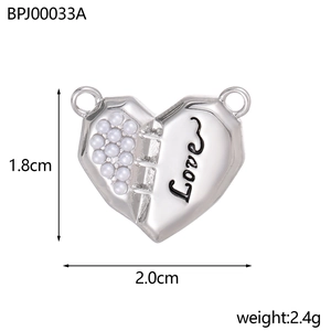 Detailed view of silver heart pendant featuring half pearl inlay and Love engraving