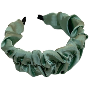 Sage green ruched satin headband with a puff cloud design for a sweet elegant hairstyle