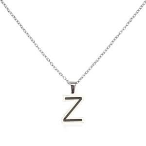 Macro detail of silver stainless steel Z letter pendant with black enamel inlay