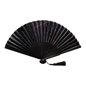 Traditional Chinese black folding fan with red bamboo leaves, tassel, and silk fabric