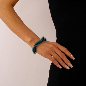 Detailed view of irregular dark green marble resin cuff bracelet with wave texture