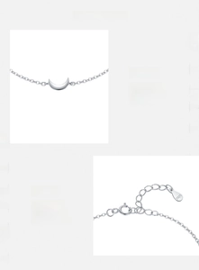 Macro shot of S925 sterling silver moon pendant and polished chain with hallmark