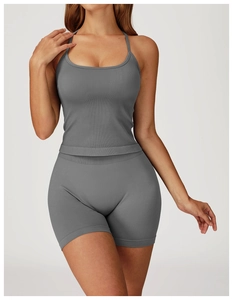 Close-up of grey ribbed seamless yoga set showing racerback tank top and biker shorts