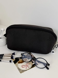 Minimalist black macaron style travel toiletry bag with large capacity and zipper closure