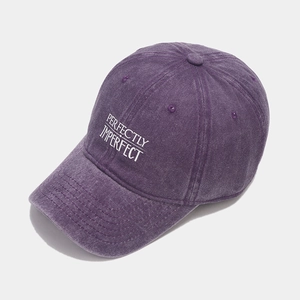 Close-up of vintage washed purple baseball cap with Perfectly Imperfect embroidery