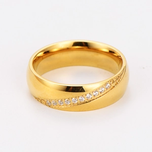 Macro view of polished gold stainless steel ring with curved row of white zircons