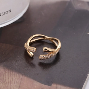 Luxurious gold geometric open ring with shimmering zircon stones on a fashion magazine