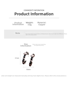 Detailed view of C-shaped copper earrings with black leather chain and white floral motifs
