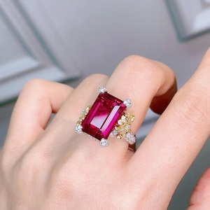 Floral camellia ruby red ring with emerald cut gemstone and golden floral accents